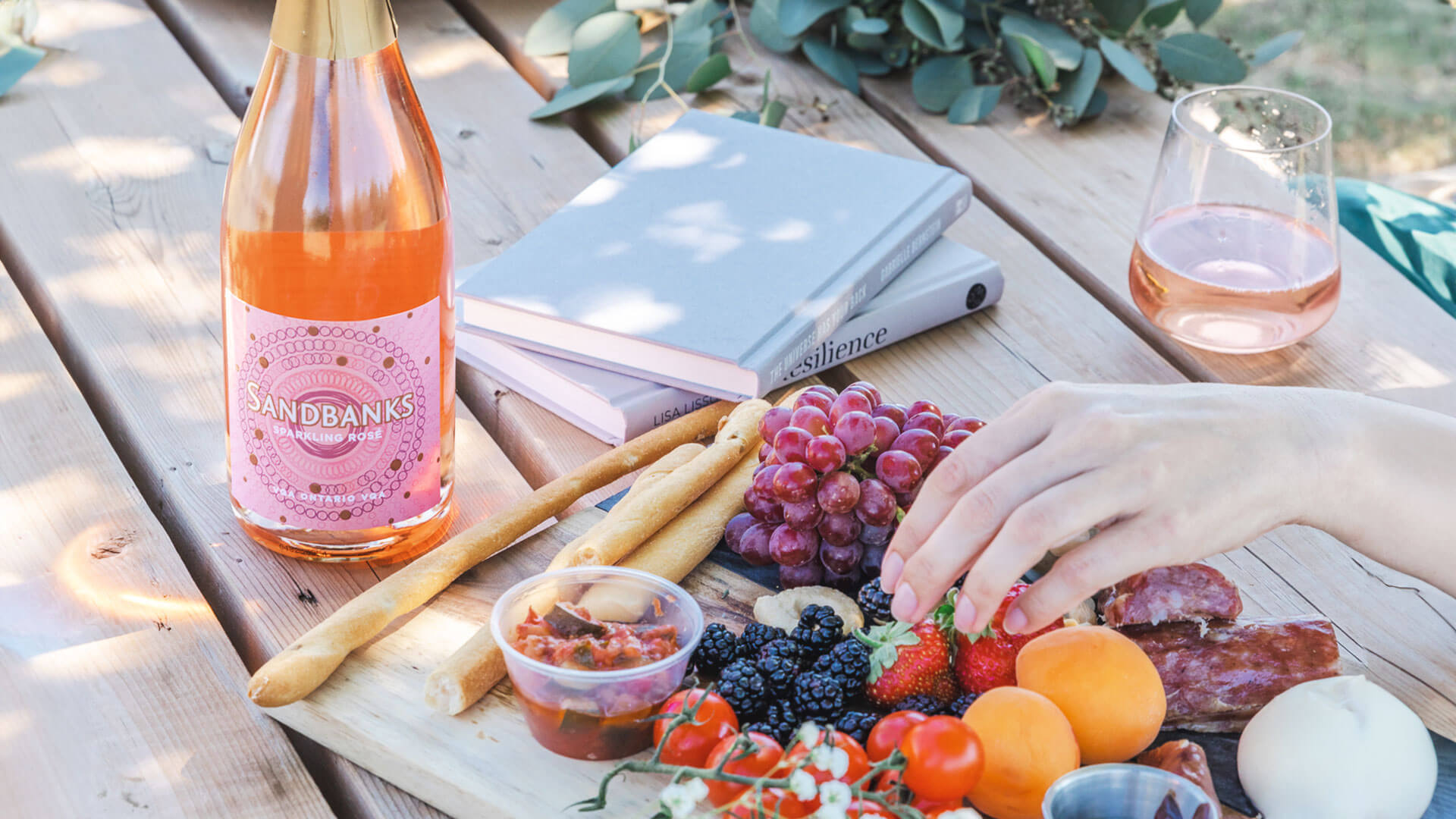 Enjoying a glass of Sandbanks Sparkling Rose with some fruits and berries